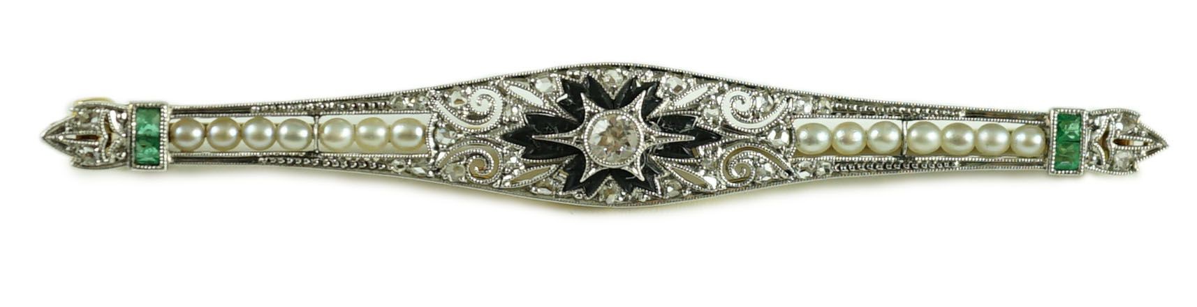 A 1920's gold and platinum, emerald, seed pearl, diamond and black onyx set bar brooch